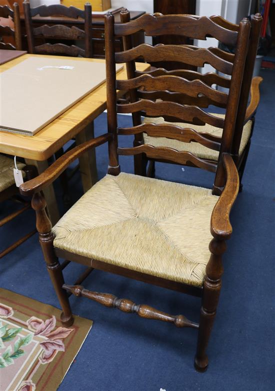 A Harlequin set of eleven rush seated oak ladder back dining chairs, including two carvers